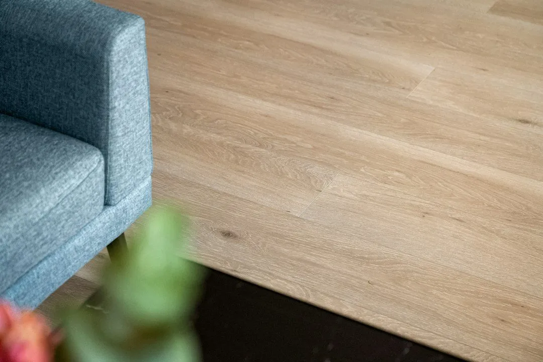 A blue chair sitting on top of a wooden floor